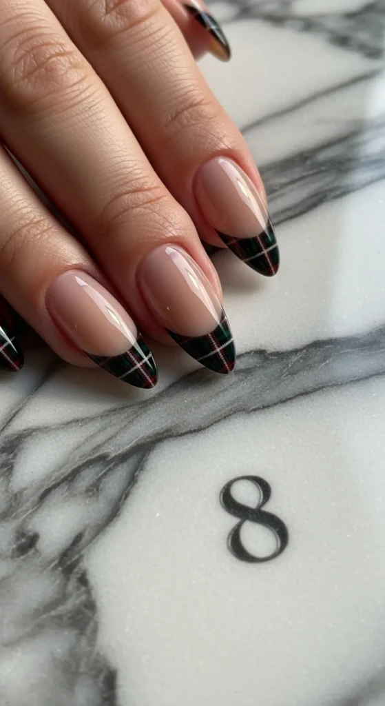 15 Fall Nail Art Ideas for 2026: Warm Tones, Foils & Seasonal Styles 12 Almond-shaped beige nails with black plaid tips, photographed close-up on a marble background.