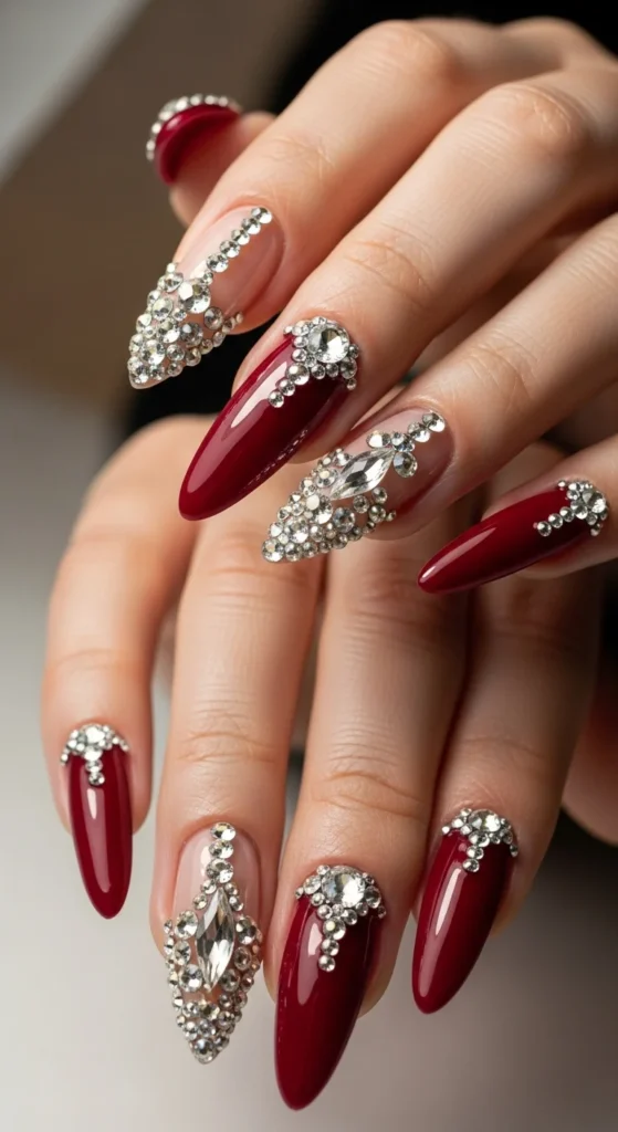 Crimson almond nails with rhinestones.