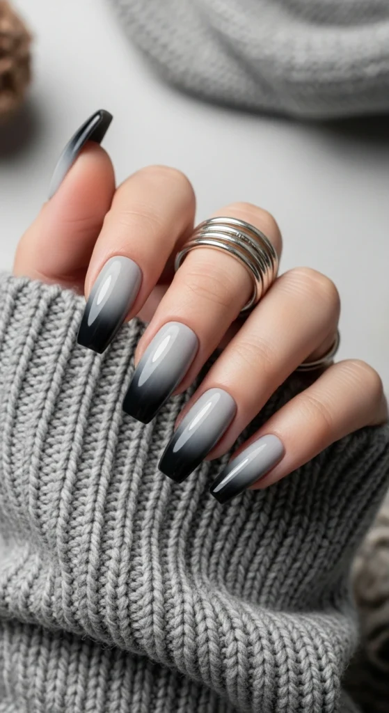 Almond nails with a soft smoky grey ombre fade, minimal yet spooky Halloween nail design.