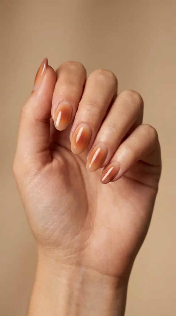 September Nails Inspiration: 13 Must-Try Manis That Scream Summer’s Final Glow 9 Amber terracotta aura nails with a sheer nude glossy base