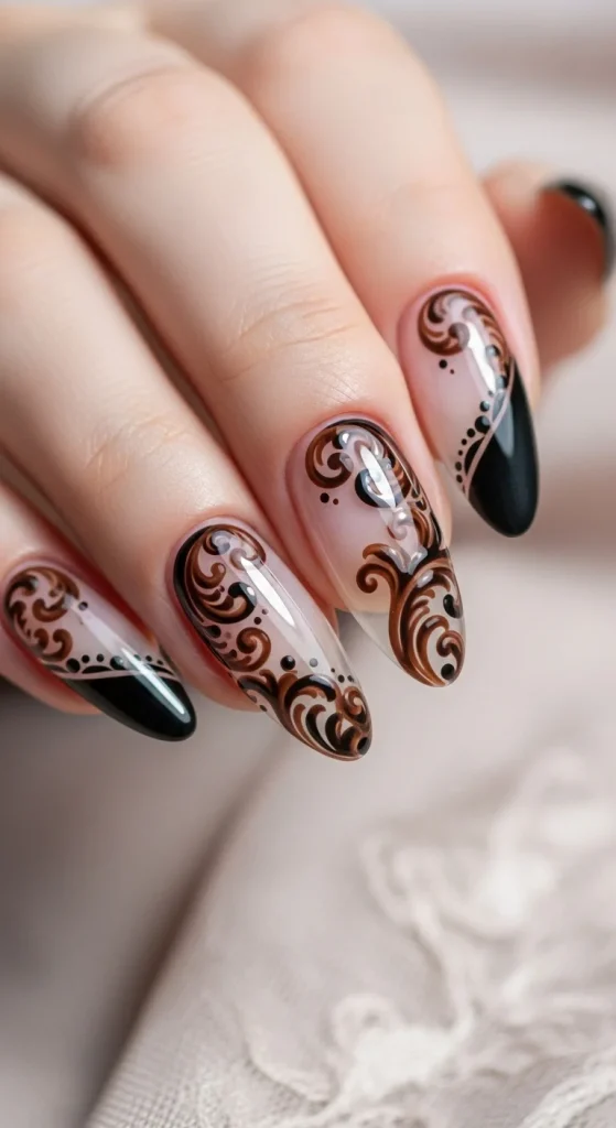 Baroque scroll negative-space nails — clear base with ornate dark scroll designs.