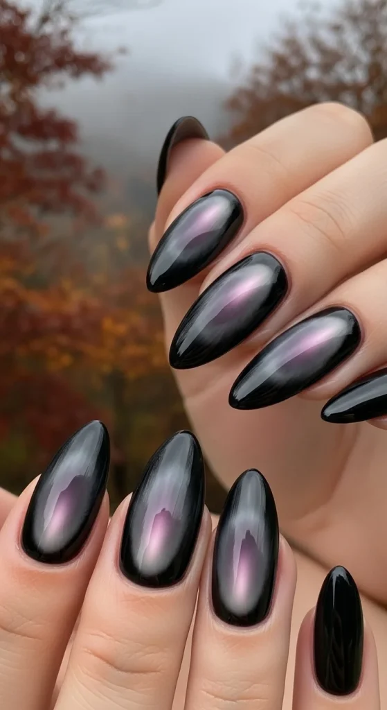 Black Fall Nails 2026: 19 Trendy Designs You’ll Love 16 Black almond nails with smoky aura glow in plum and grey, moody background."