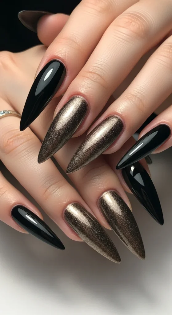 Stiletto nails with black and bronze gradient.
