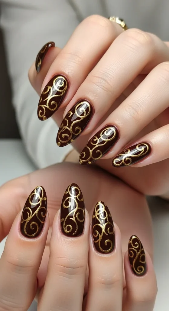 Chocolate and gold swirl almond nails, elegant autumn 2025.