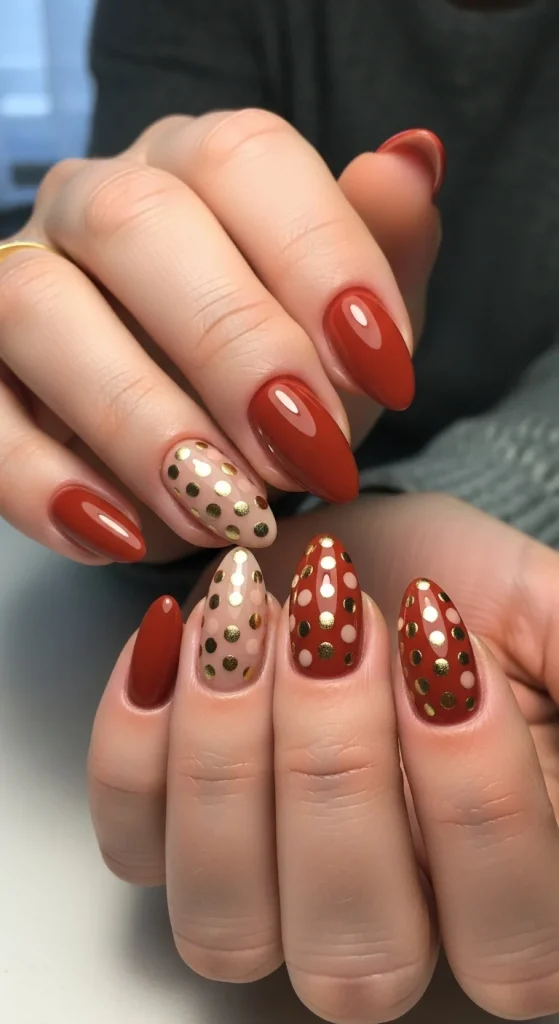 Warm cinnamon red nails with beige and gold polka dots