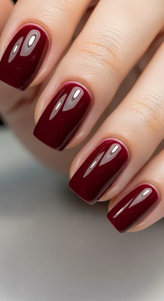 Short oval nails with black cherry  red ruby polish