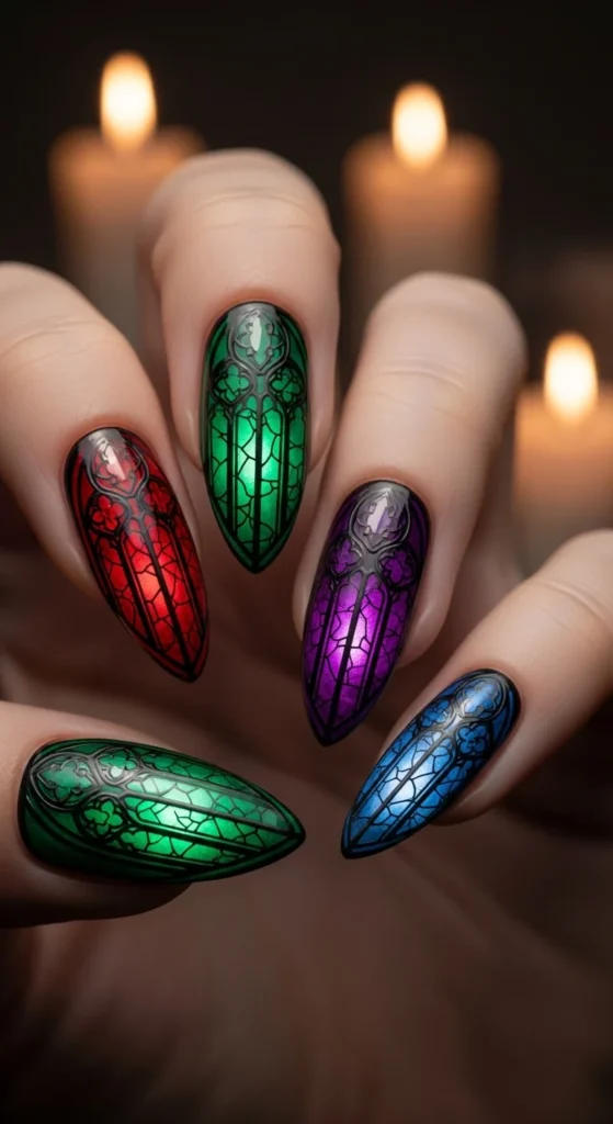 Almond nails with dark stained-glass window designs in jewel tones.