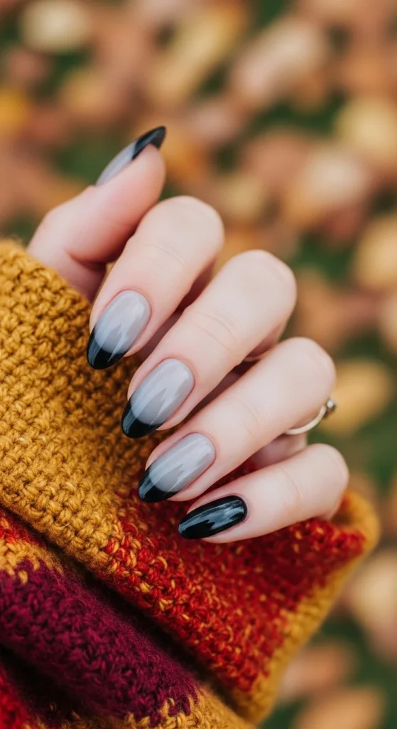 Black Fall Nails 2026: 19 Trendy Designs You’ll Love 8 Grey-to-black ombré French nails, styled with fall scarf.