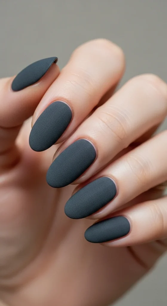 Oval nails in matte charcoal polish.