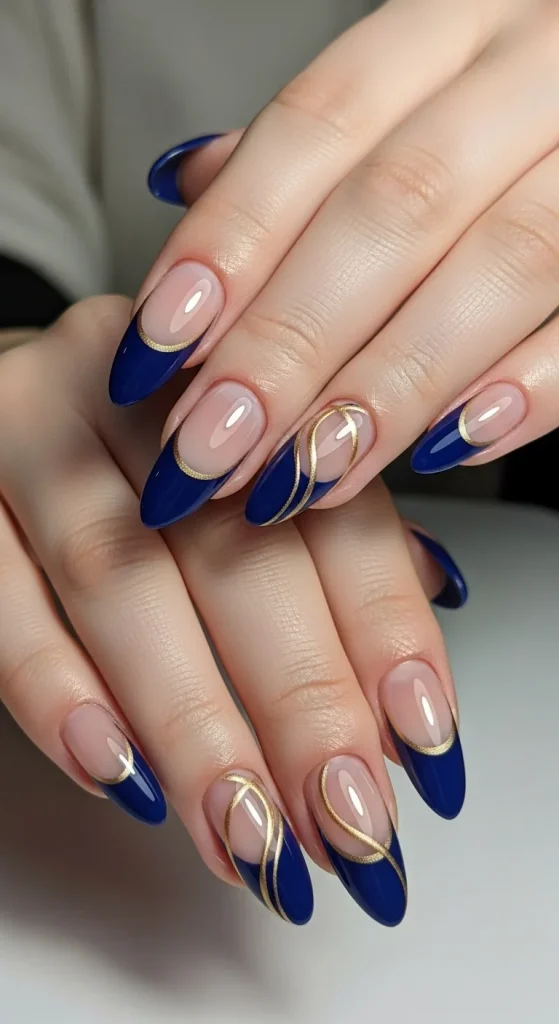 20 Chic September Nail Designs for 2026 That Capture Fall’s First Glow 4 Midnight blue French tip nails with gold swirl accents.