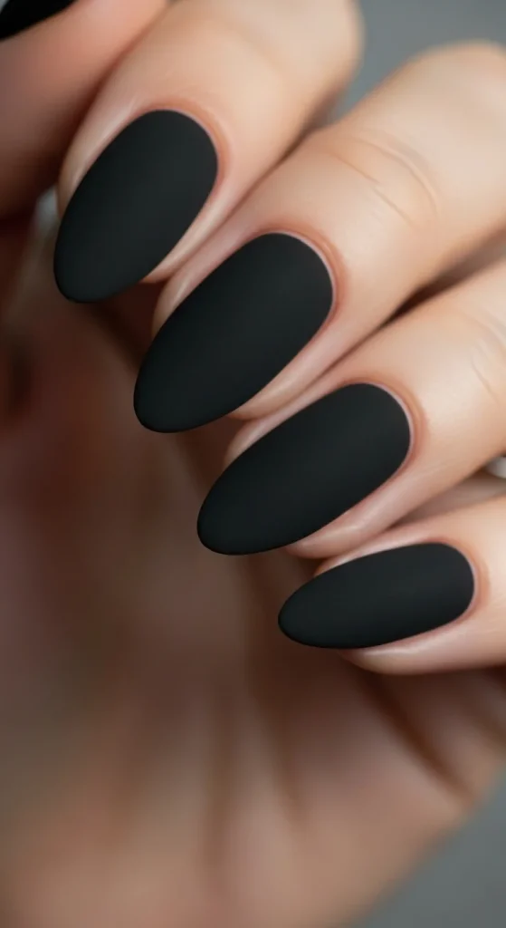 Almond nails with matte black velvet polish.
