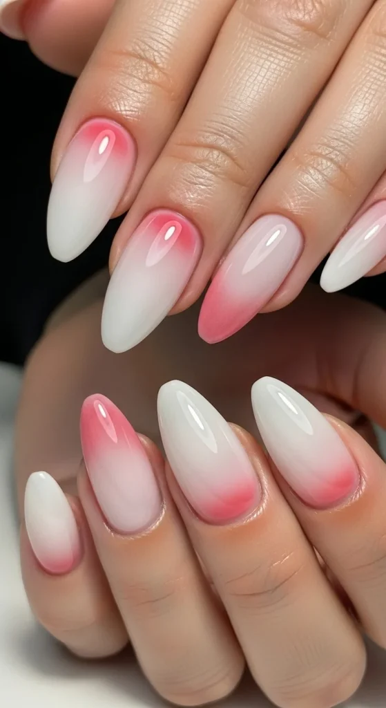 Milky sheer white and pink almond nails with glossy finish — trending nail design for 2026.