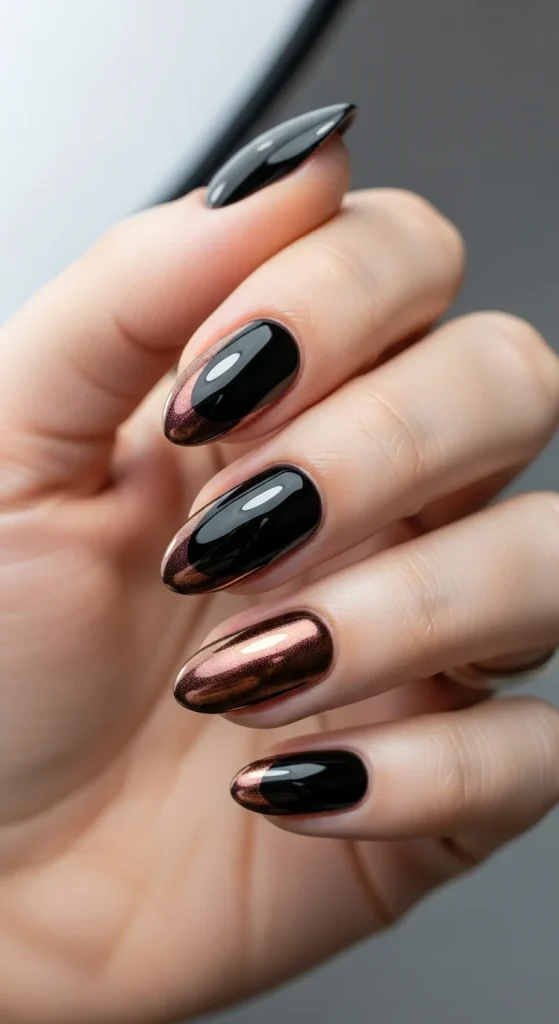 Black almond nails with bronze chrome tips.
