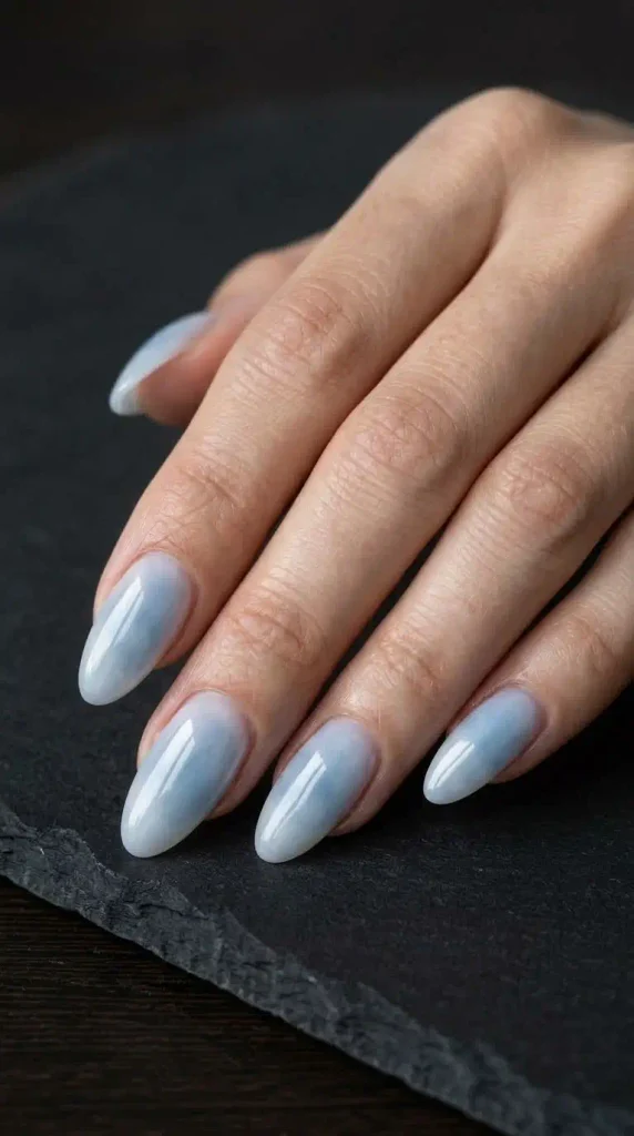 September Nails Inspiration: 13 Must-Try Manis That Scream Summer’s Final Glow 7 Misty blue glass nails with a soft milky glaze and glossy finish