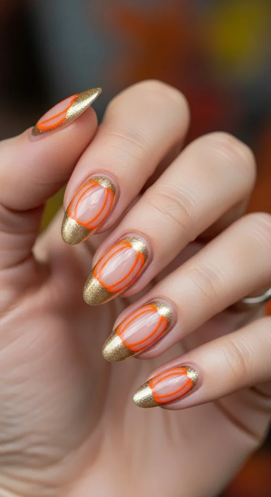 Negative space nails with pumpkin shape outlined in orange and gold.