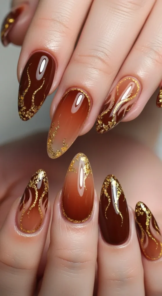 Nutmeg brown aura nails with amber glow and gold flame tips