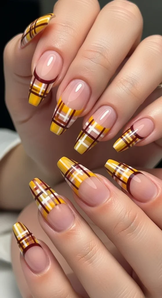 French tips with plaid design in mustard, cream, and burgundy over nude base
