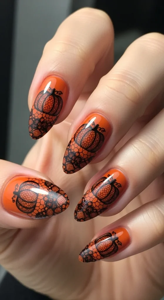 Almond nails with black lace pumpkin overlay on burnt orange base