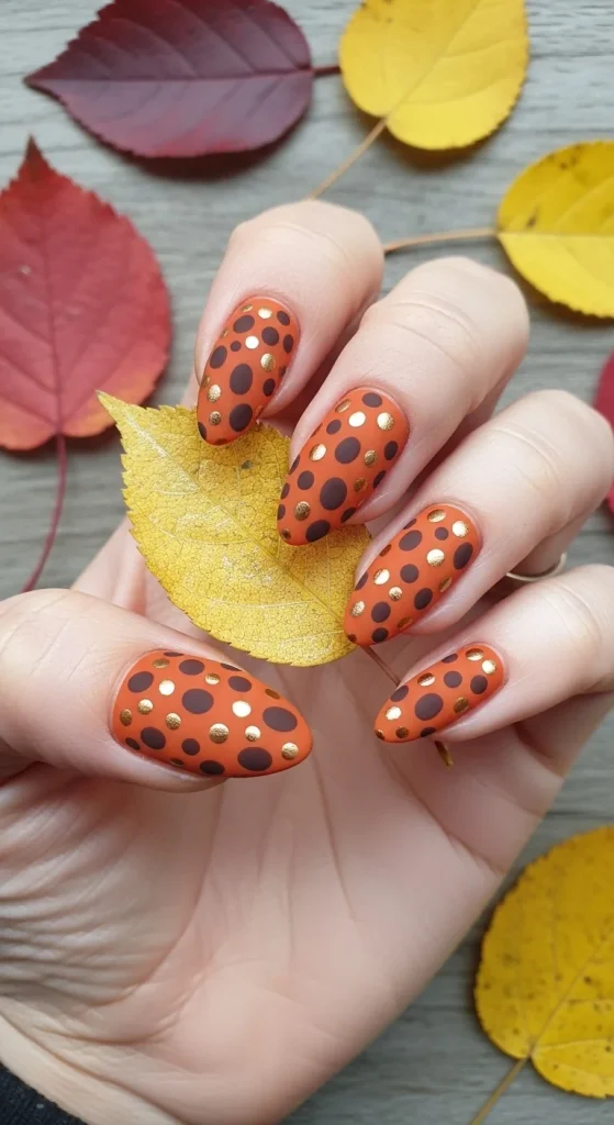 Burnt orange pumpkin patch polka dot fall nails 2025.