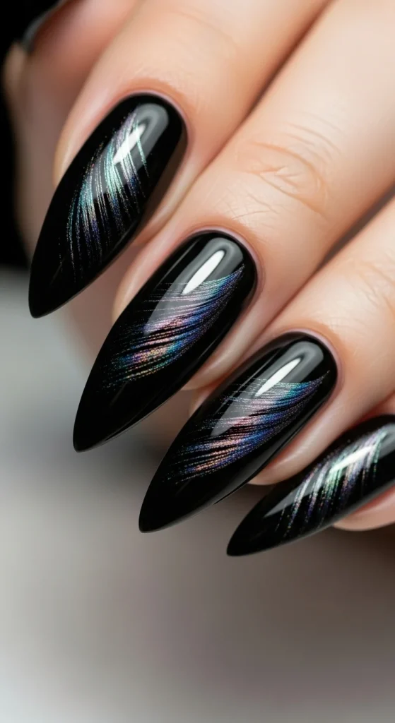 Black stiletto nails with feather shimmer accents.