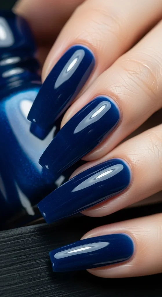 Coffin nails in glossy sapphire polish.
