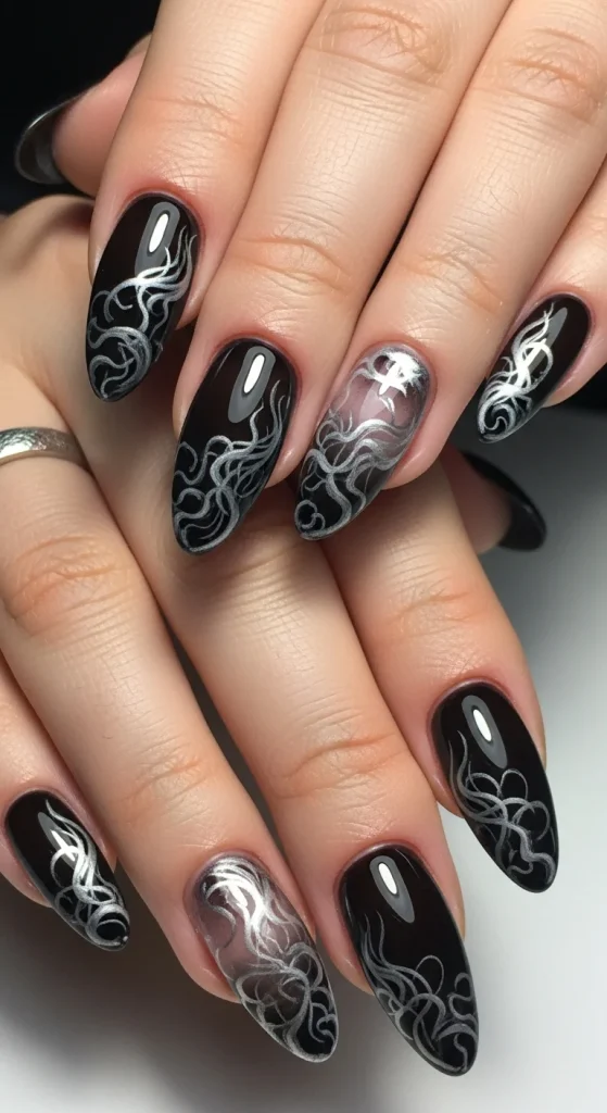Almond nails with sheer black base and silver-gray smoky wisps, haunting but elegant