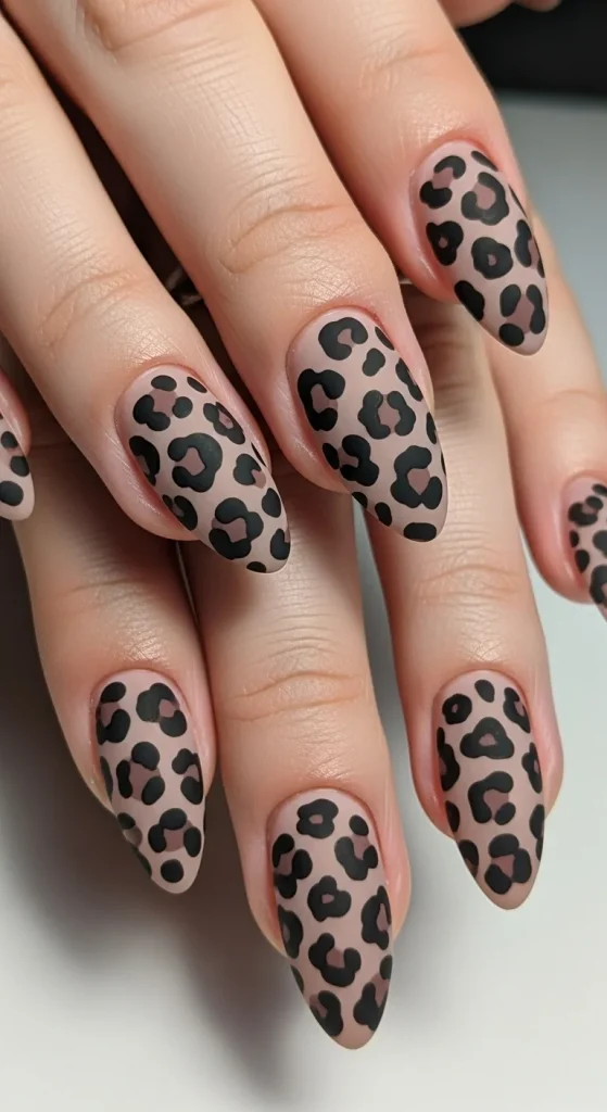 Taupe nails with black leopard contrast design for Fall 2025.