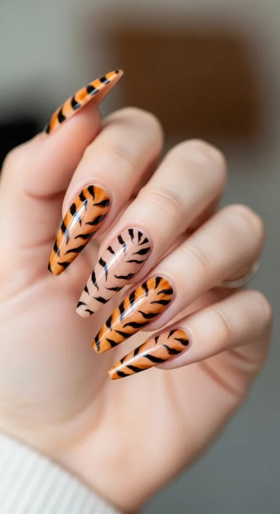 Tiger stripe accent nails for bold fall manicure.