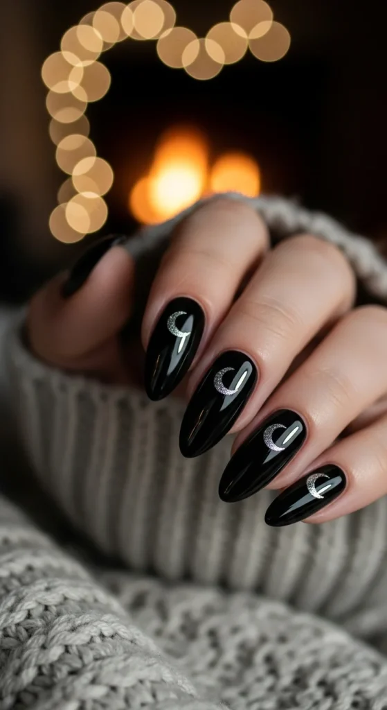 Black Fall Nails 2026: 19 Trendy Designs You’ll Love 12 Black almond nails with silver crescent moons