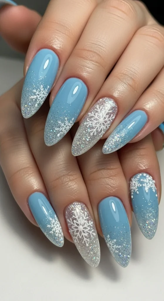 Baby blue glitter ombré nails with frosty gradient for winter wonderland theme.