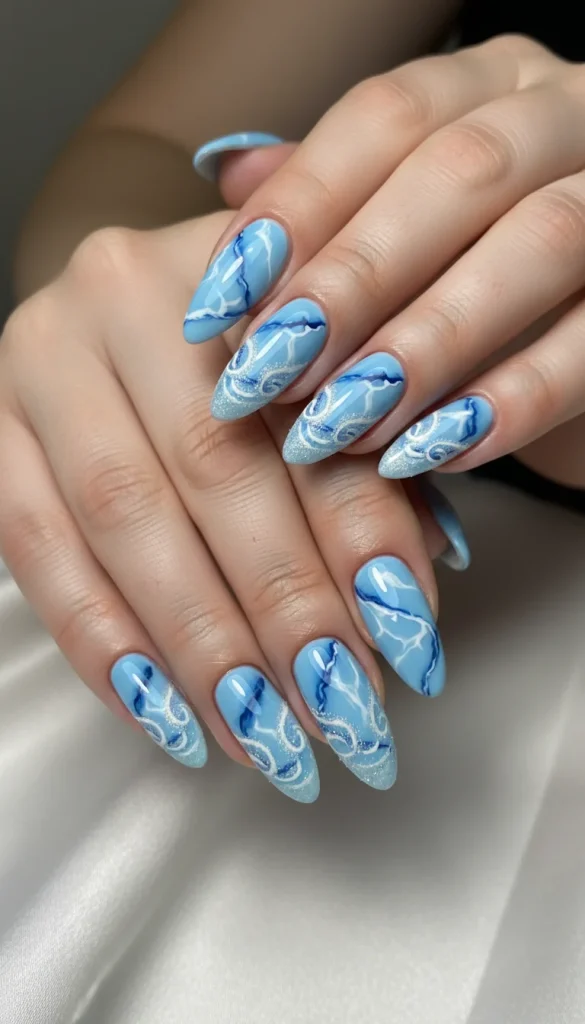 Blue marble frost nails with swirling white and silver winter design.