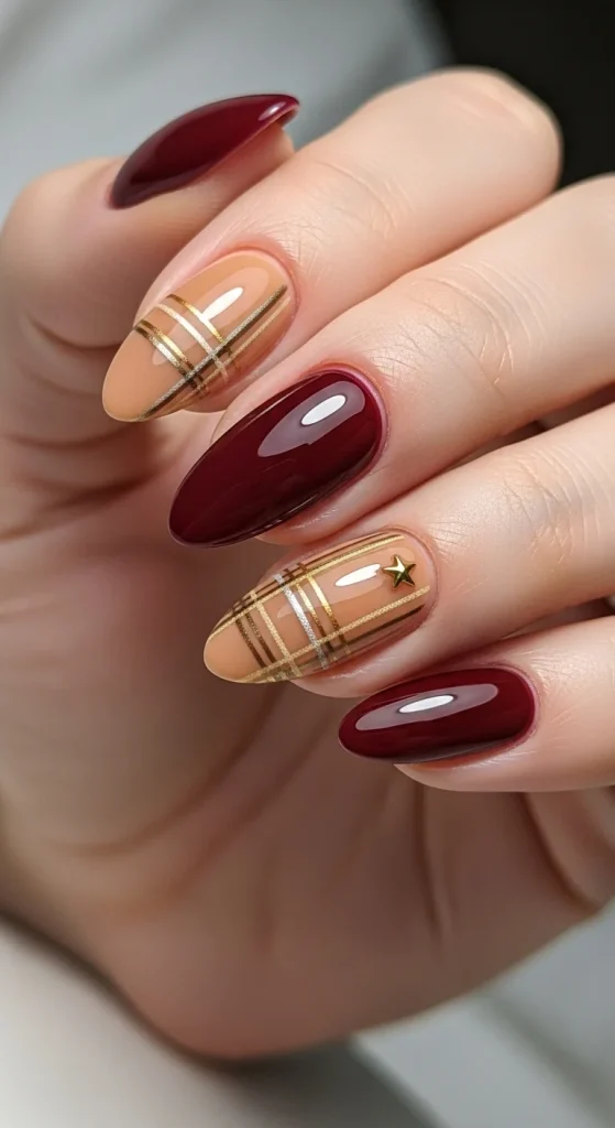 Plaid Nails with Cozy Sweater Texture: Holiday Nail Designs 2025 16 Glossy burgundy nails with camel plaid accent and gold star detail.