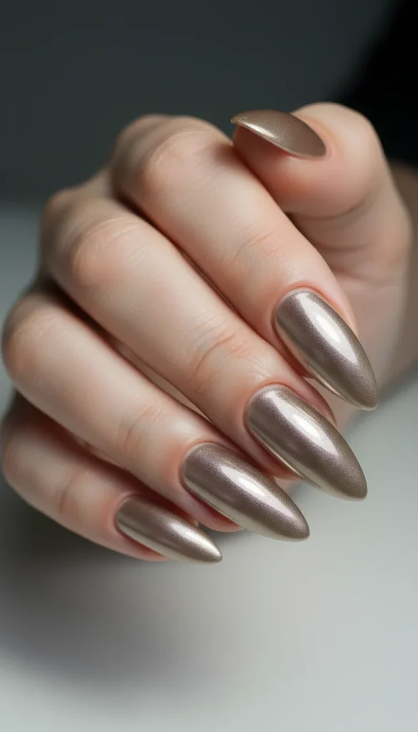 Neutral Holiday Nails 2025: 21 Elegant & Festive Nude Nail Designs 2 Champagne nude chrome holiday nails with glossy metallic shine.