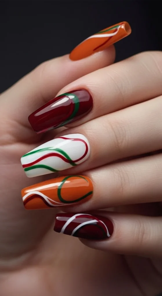 15 Red Nail Designs 2026: Cherry, Dark & Trendy Ideas You’ll Love 7 Long almond nails painted in cherry red, burnt orange, and cream with curved swirl line accents in green and black, creating a stylish multi-tone manicure inspired by fall colors.