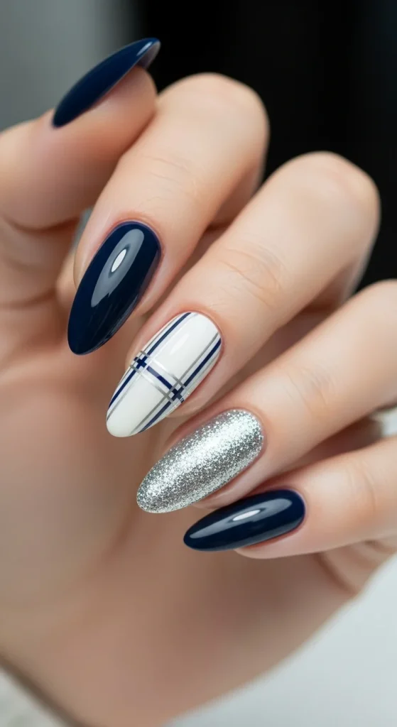 Plaid Nails with Cozy Sweater Texture: Holiday Nail Designs 2025 12 Midnight navy nails with cream plaid accent and silver glitter nail.