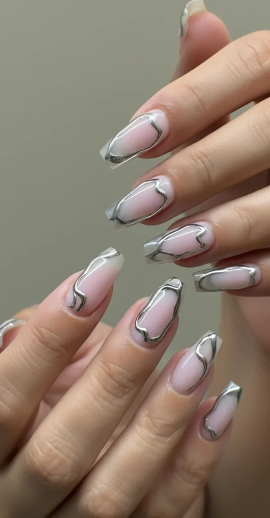 Chrome embellished nude coffin nails, glam nail trends 2026.