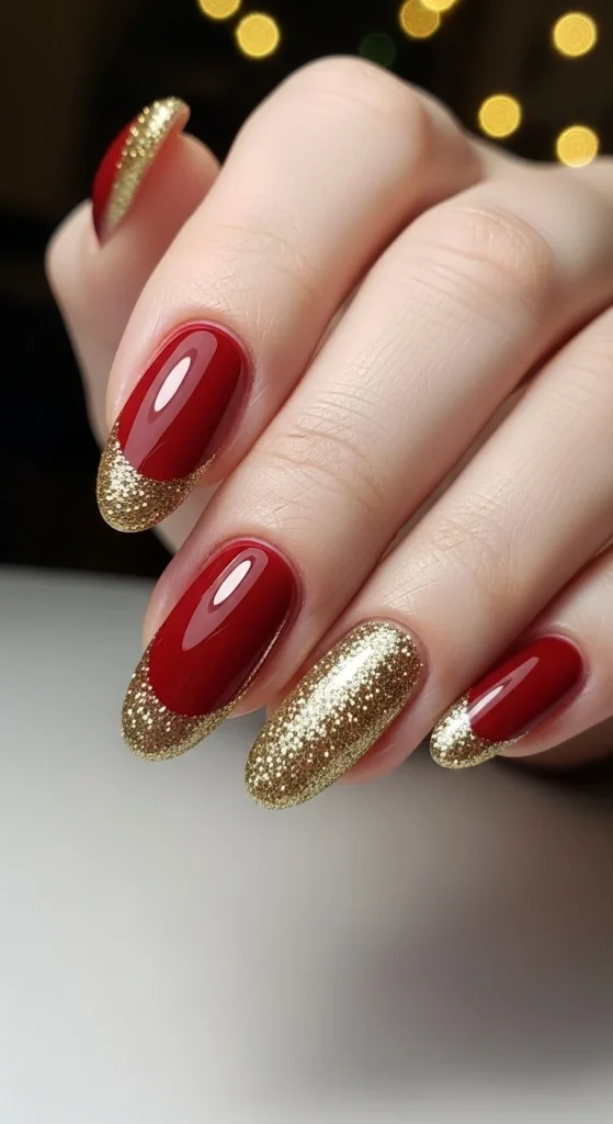 Classic Christmas Nails 2025: 21 Timeless Holiday Nail Designs 3 Red and gold French tip Christmas nails with glitter accents for an elegant holiday look.