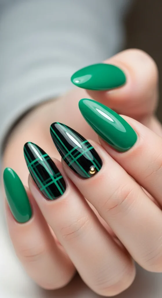 Plaid Nails with Cozy Sweater Texture: Holiday Nail Designs 2025 19 Emerald green nails with black plaid accent and gold stud.