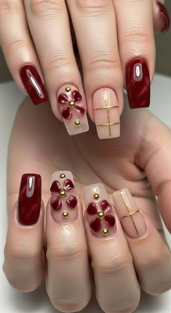 15 Red Nail Designs 2026: Cherry, Dark & Trendy Ideas You’ll Love 3 Dark cherry red nails with black floral art accents, combining romantic and gothic styles for a modern fall look.