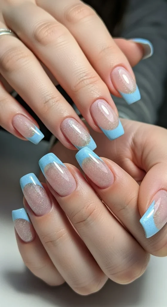 Icy blue French tip nails with nude base and frosty shimmer for winter 2025.