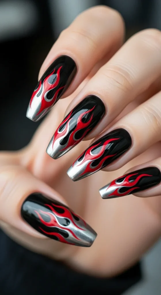 Black nails with metallic chrome flame tips in red and silver.