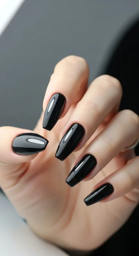 Glossy jet-black almond and coffin nails with a mirror-like shine