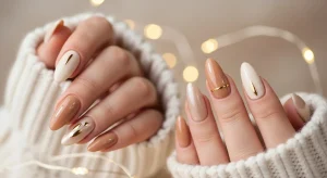 Neutral holiday nails 2025 with nude, beige, and champagne tones featuring chrome and shimmer finishes in a cozy festive setting.