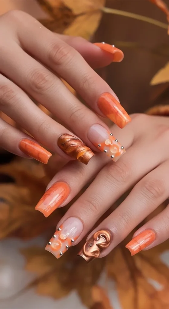 Pumpkin orange chrome gel nails with glossy shine and fall aesthetic.