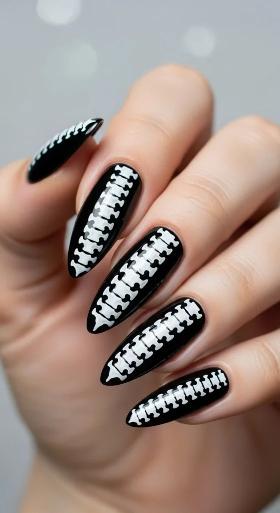 Spine Chiller Halloween nails with white spine design on black base.