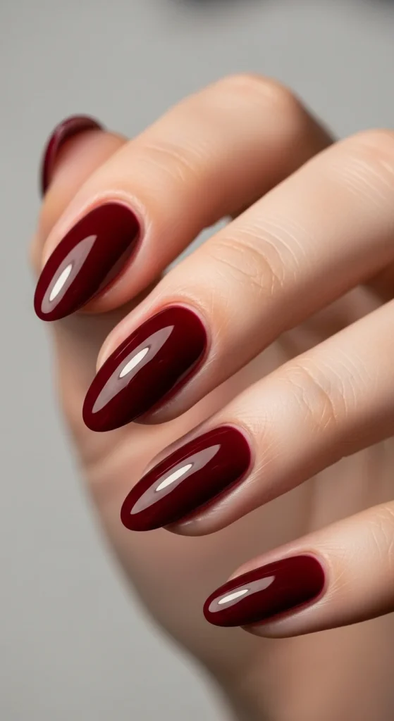 15 Red Nail Designs 2026: Cherry, Dark & Trendy Ideas You’ll Love 2 Short almond nails painted in glossy dark cherry merlot color, giving a luxurious wine-stained look.