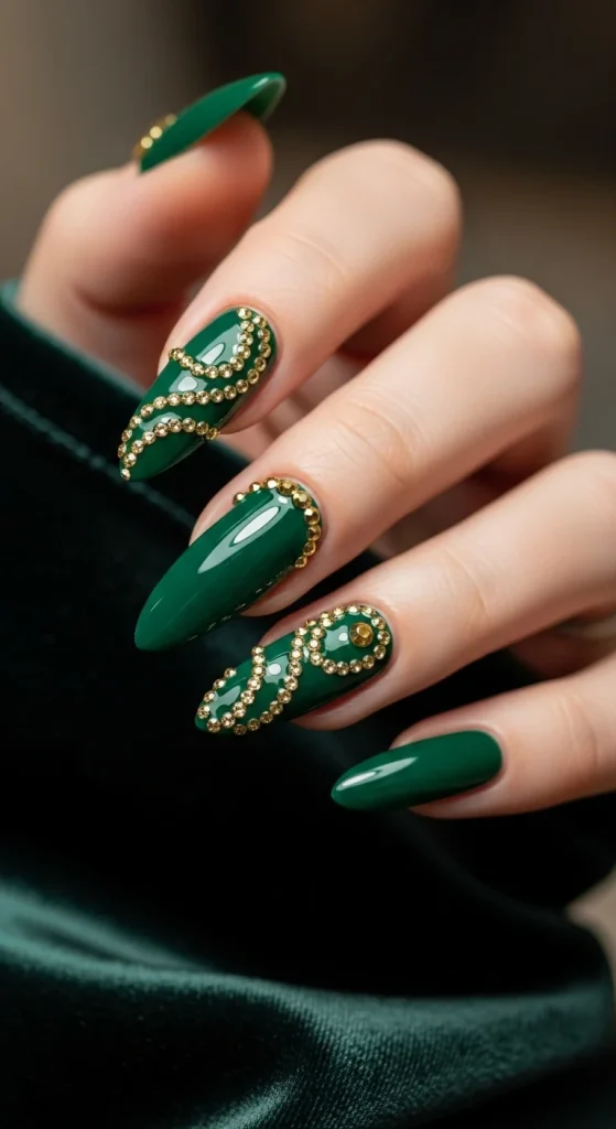 Emerald green nails with gold gemstone accents.