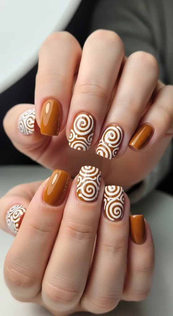 Short Holiday Nails 2025: 21 Festive & Chic Ideas for Every Occasion 21 Short caramel nails with white gingerbread swirl design