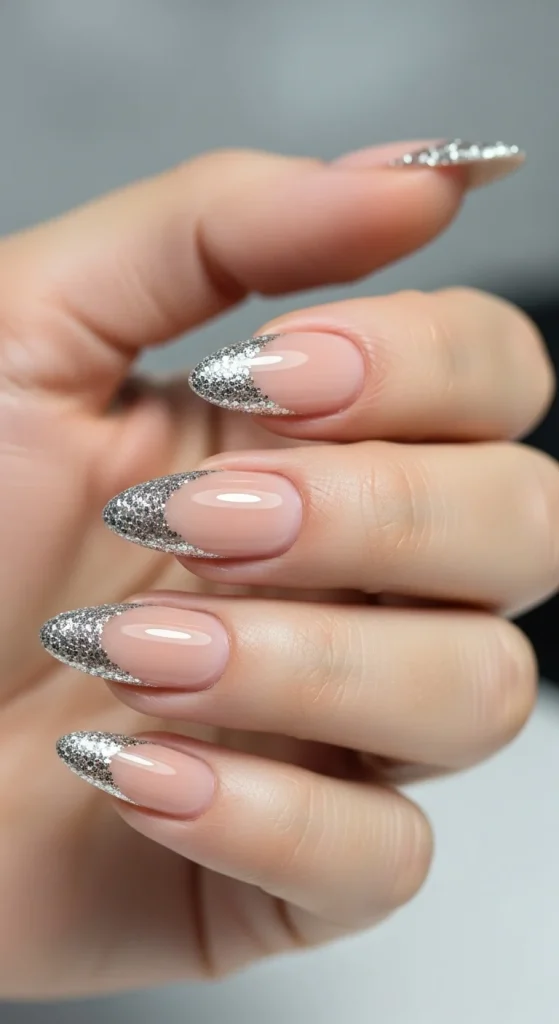 Nude nails with reverse silver glitter cuticle accent.