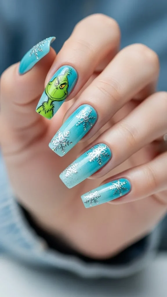 Grinch Nails: Festive Ideas, Designs & the Ultimate Christmas Nail Guide 17 nails with a blue icy gradient, lime-green Grinch character art, and silver snowflake accents, shown with a glossy finish under cool winter-wonderland lighting.